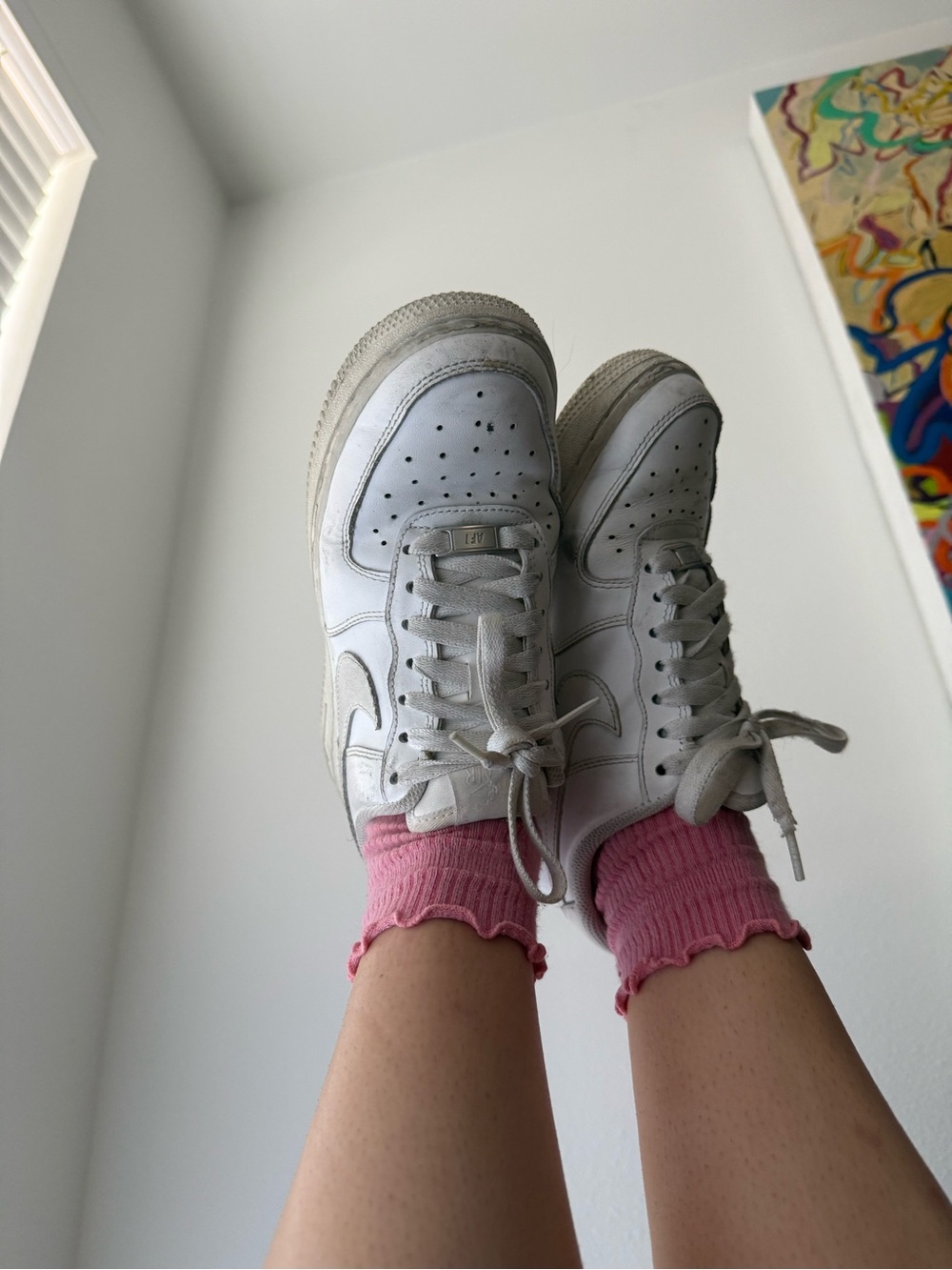 Well worn Nike white leather low-top sneakers